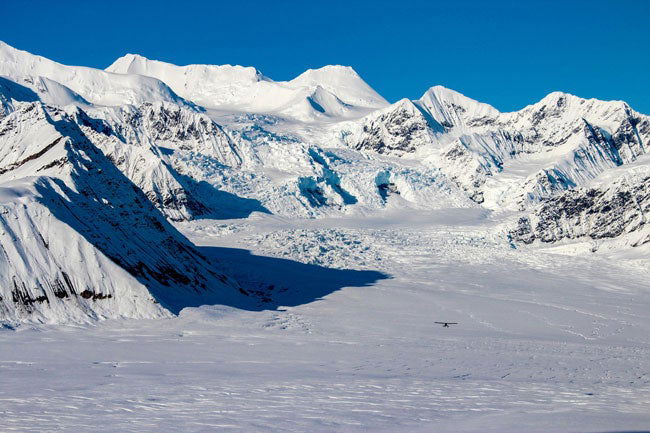 Small plane flies over Alaskan mountains