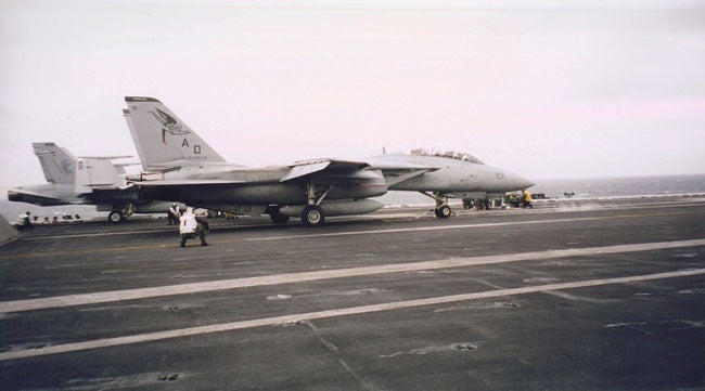 F-14 Tomactas and F/A-18 Hornets launching off the USS Enterprise