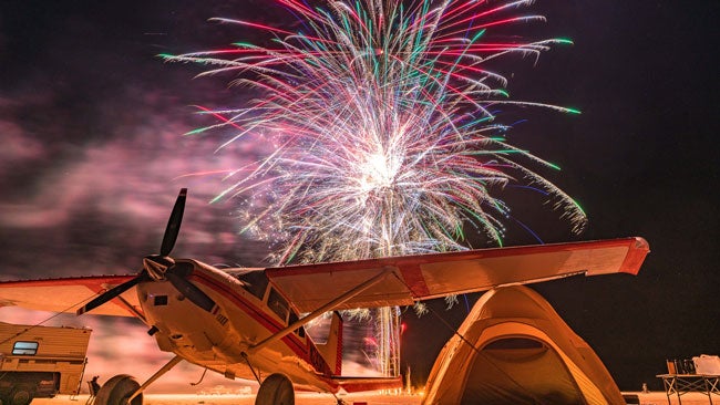 Fireworks behind a Cessna 185 at the High Sierra Fly-In