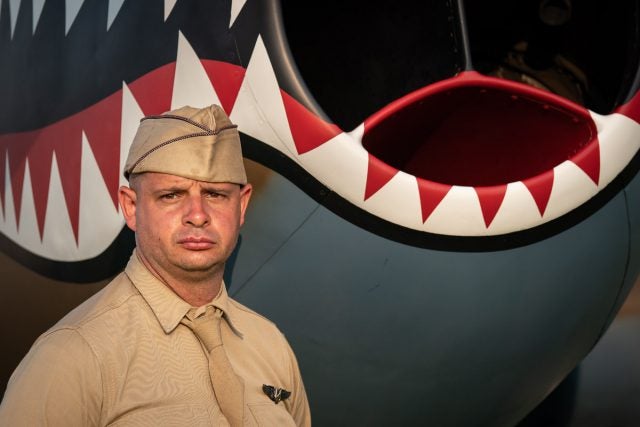 A re-enacter posing with a P-40
