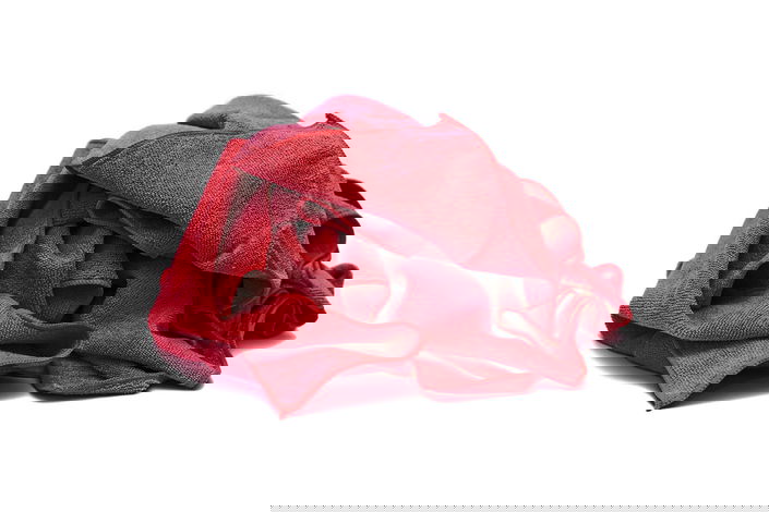 It was determined that fibers from a red shop towel in the fuel selector valve led to an unusual fuel starvation mishap.