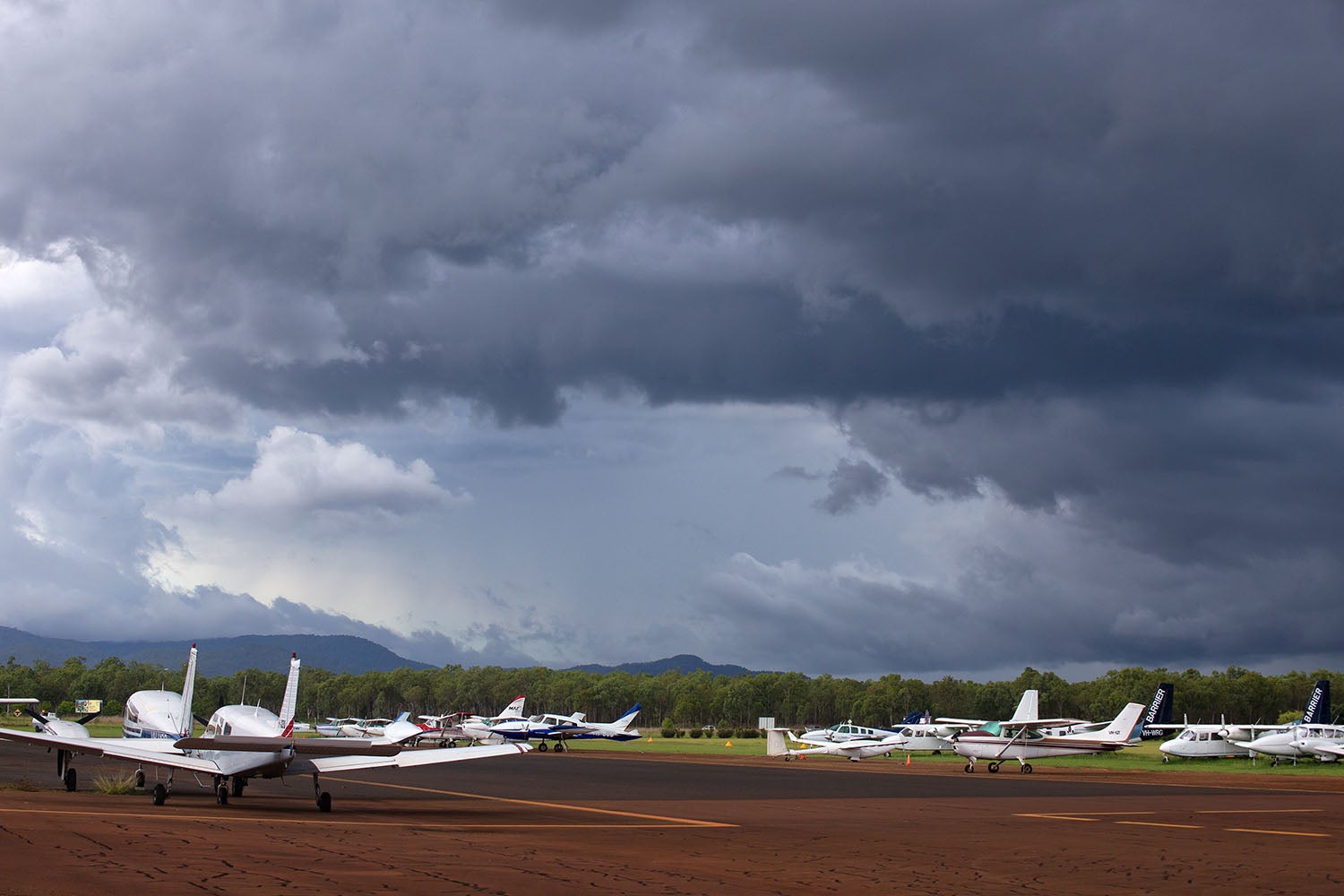 Small planes with storm clouds overhead
