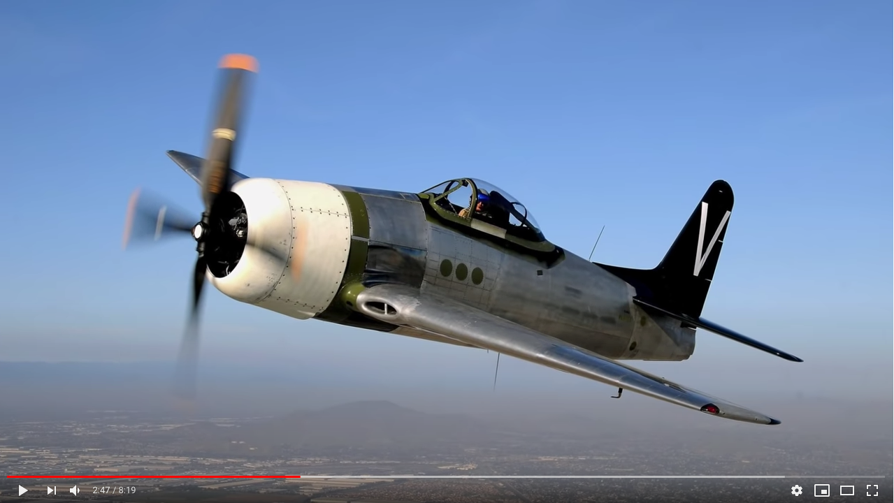 A screenshot of a restored Grumman F8F Bearcat in flight.