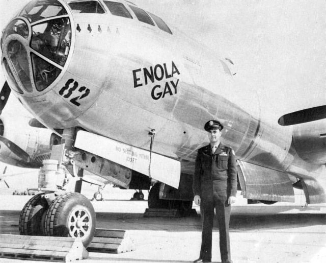 Col. Paul Tibbetts stands in front of Boeing B-29 Superfortress Enola Gay.