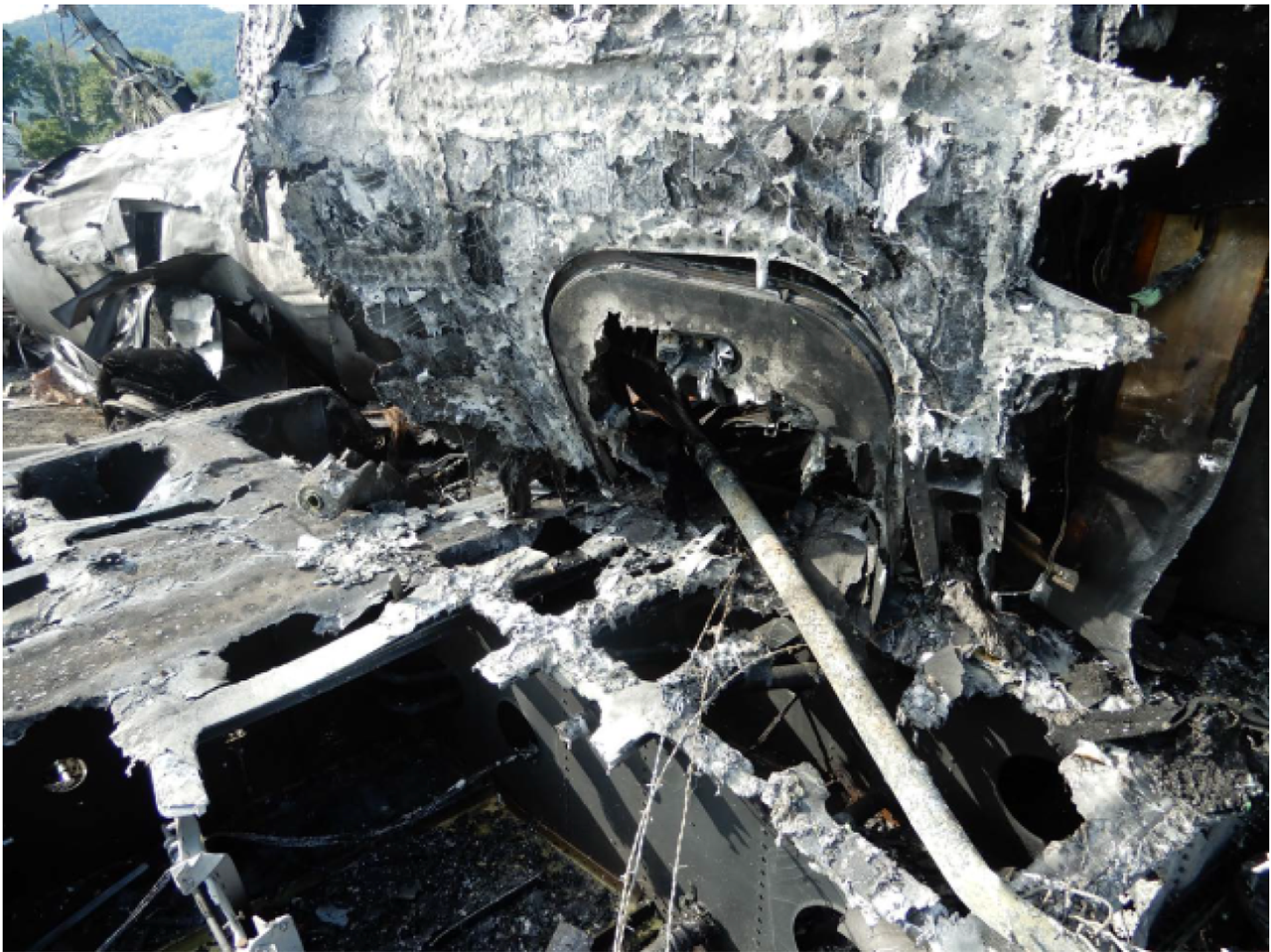 The emergency escape hatch of Dale Earnhardt, Jr's plane impaled by a metal fence post. Photo courtesy of NTSB