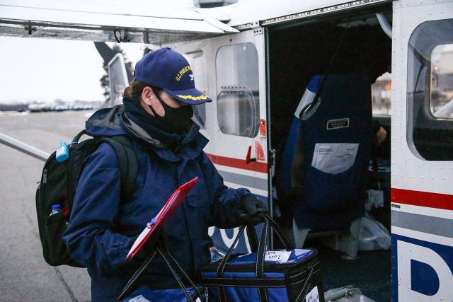 Loading the precious goods into to the back of the Civil Air Patrol GA-8.