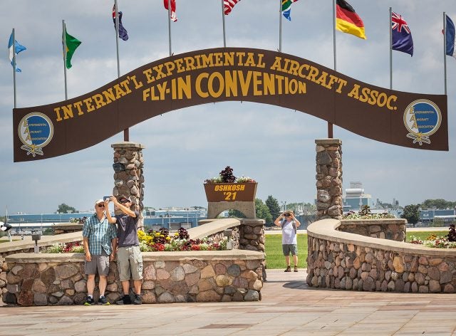 What is said to be the first selfies shot in front of the Brown Arch at an AirVenture Oshkosh show in two years. Photo by Jim Koepnick