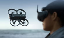 Drone in flight with pilot watching