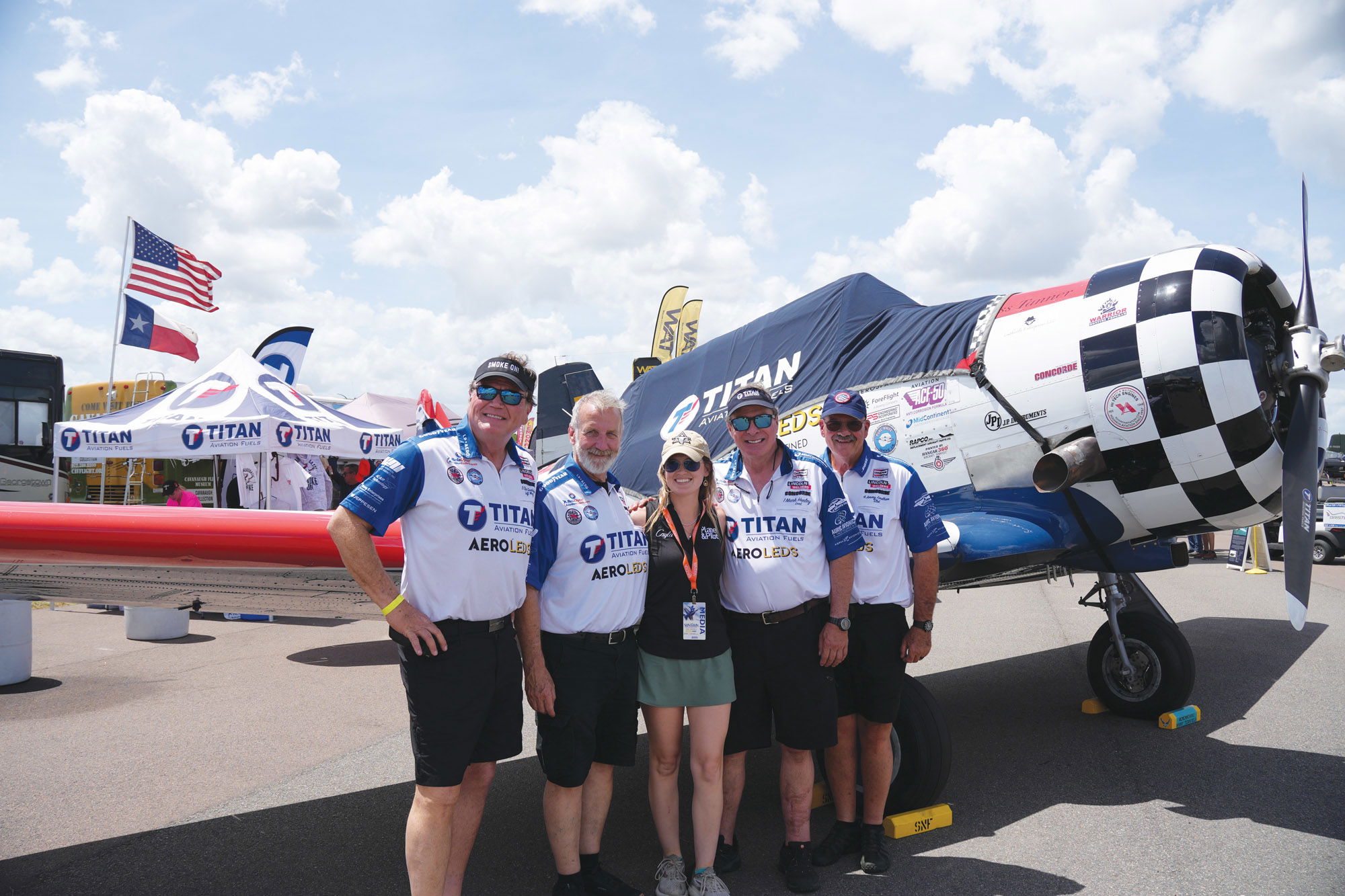 Gustafson (from left), Regan, McLeod, Henley, and Fordham pose in front of the Titan booth after their flight.